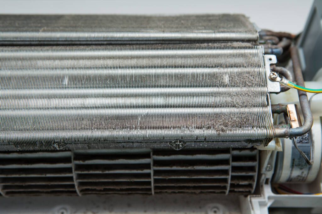 Close-up of a dirty refrigeration coil indicating the need for preventive maintenance