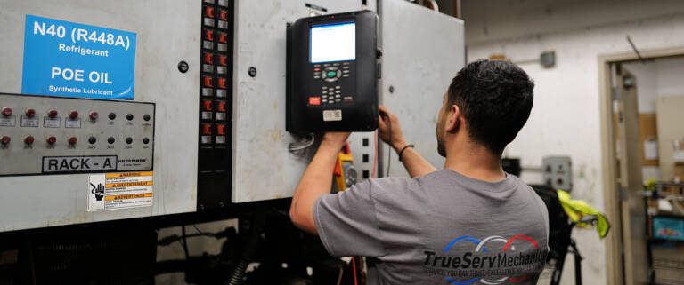 An energy management system is being worked on by a service technician