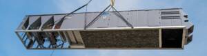 Commercial HVAC rooftop unit being lifted by crane for installation in North Texas.