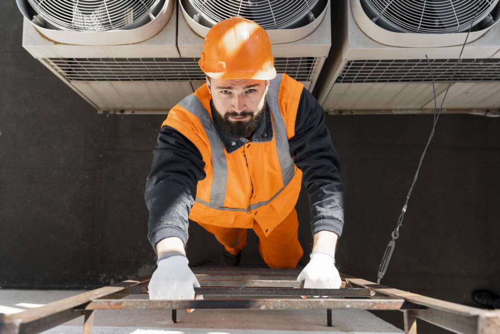 Commercial AC repair in Dallas technician climbing a ladder to service a rooftop HVAC unit