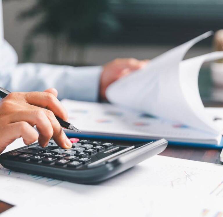 Businessperson calculating repair costs resulting from lack of preventive maintenance