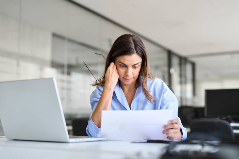 Business owner reviewing an energy bill to evaluate commercial HVAC and refrigeration operating costs