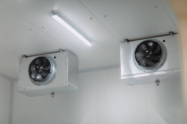 Fans circulating air inside a commercial chilled room