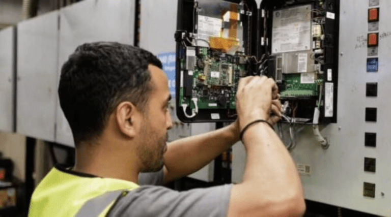 A TrueServ Mechanical technician works on commercial energy management systems.