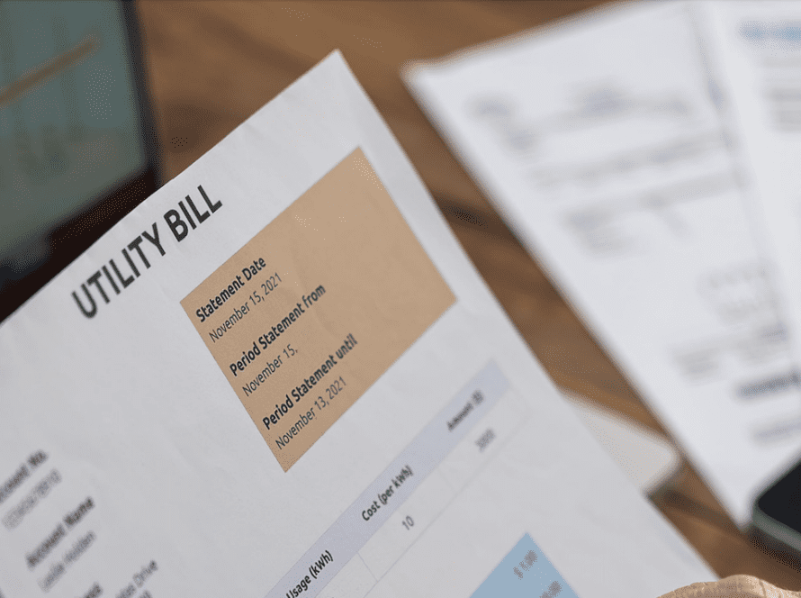 An image of a utility bill represents the concept of lowering commercial energy consumption