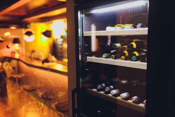 Commercial wine display case chiller in a restaurant, maintaining precise refrigeration and temperature control for beverage storage and customer display.